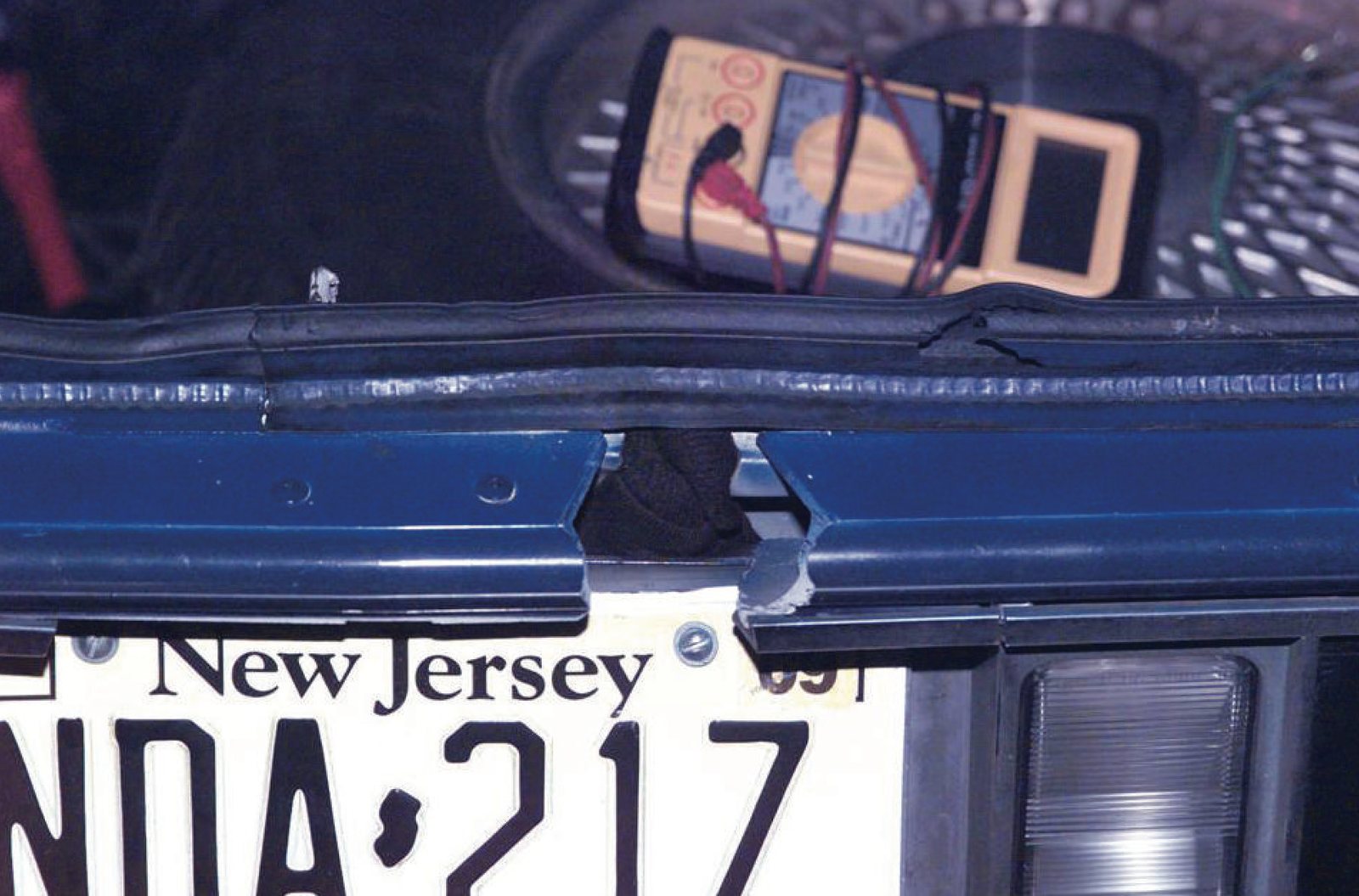 Firing port cut in the trunk lid of the 1990 Chevrolet Caprice used by Muhammad and Malvo